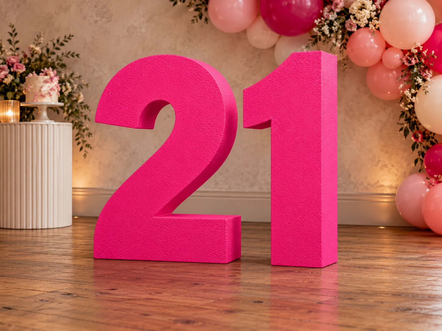 Illustrative hot pink freestanding foam birthday numbers 21 at a celebration venue